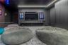 Monochromatic interior featuring floor-to-ceiling cabinetry, recessed linear perimeter lighting, and high-contrast walls