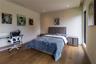 Wood-finish flooring, recessed lighting, and expansive floor-to-ceiling windows
