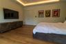 Tray ceiling featuring recessed accent lighting, wood-finish flooring, and solid-core double doors