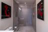 Walk-in shower featuring a frameless glass enclosure, neutral tile surround, built-in wall niche, and integrated linear drain