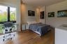 Wood-finish flooring, recessed ceiling lighting, and floor-to-ceiling glass paneling featuring a black frame