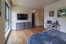 Wood-finish flooring, recessed lighting, large-format windows, and custom walk-in closet with built-in shelving