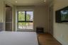 Room featuring recessed lighting, dark wood-finish flooring, a large dual-pane window, and two doorways