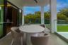 Covered terrace featuring large-format tile flooring, glass panel railings, and recessed ceiling lighting