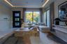 Tray ceiling with recessed perimeter lighting, floor-to-ceiling windows, modern black multi-panel entry door, and light-toned flooring