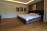 Tray ceiling with integrated recessed lighting, wood-finish flooring, and solid-core doors