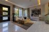 Contemporary interior featuring polished stone flooring, recessed tray ceiling with integrated perimeter lighting, large-format glass windows with bla