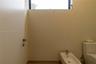 High-ceiling space featuring a clerestory window, white porcelain bidet with a chrome faucet, and a dual-flush toilet