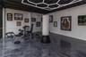 Polished concrete flooring, exposed ceiling beams, geometric LED overhead lighting, and wall-mounted climate control unit