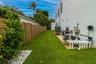 Side yard featuring synthetic turf, wood-plank privacy fencing, and exterior mechanical systems including pool equipment and HVAC unit