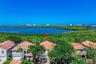 Aerial perspective showcasing this waterfront residence nestled within a lush, mature landscape