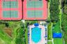 Recreational complex featuring four tennis courts, a swimming pool, a separate spa, and a shaded outdoor area with turf