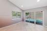 Interior space featuring vaulted ceilings, recessed lighting, tile flooring, and oversized sliding glass doors