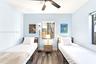 Wood-finish flooring, light blue interior paint, central ceiling fan with integrated lighting, and dual exterior-facing windows