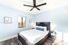 Wood-finish flooring, multi-blade ceiling fan with integrated lighting, and single-pane window with dark frame