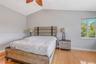 Vaulted ceilings, wood-finish flooring, and natural light from a single-pane window