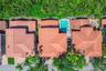 Aerial perspective of multi-structure property featuring red clay tile roofing, private swimming pool, paved patio, and mature perimeter landscaping