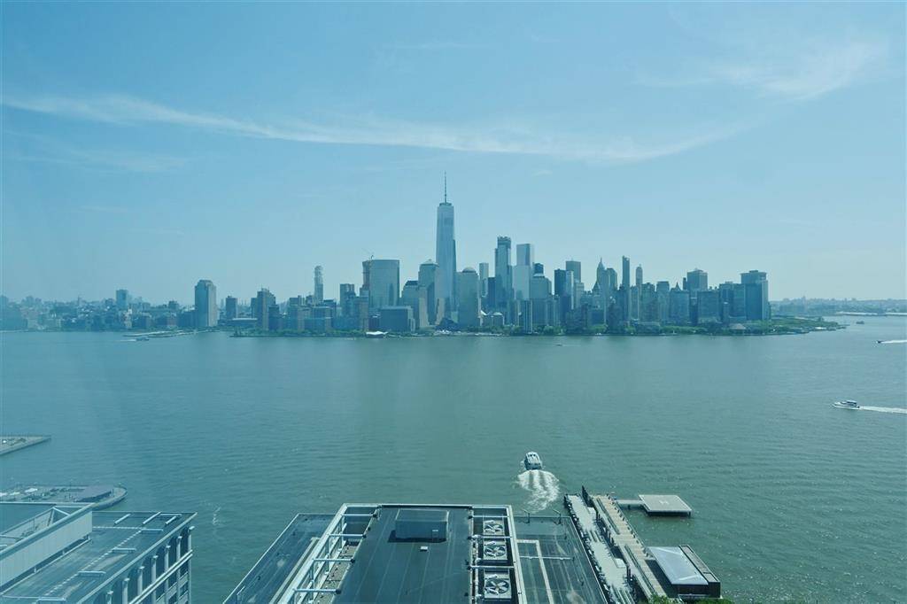 Beautiful NYC views from this 30th floor condo in prestigious downtown Jersey City building with water and city views from each room