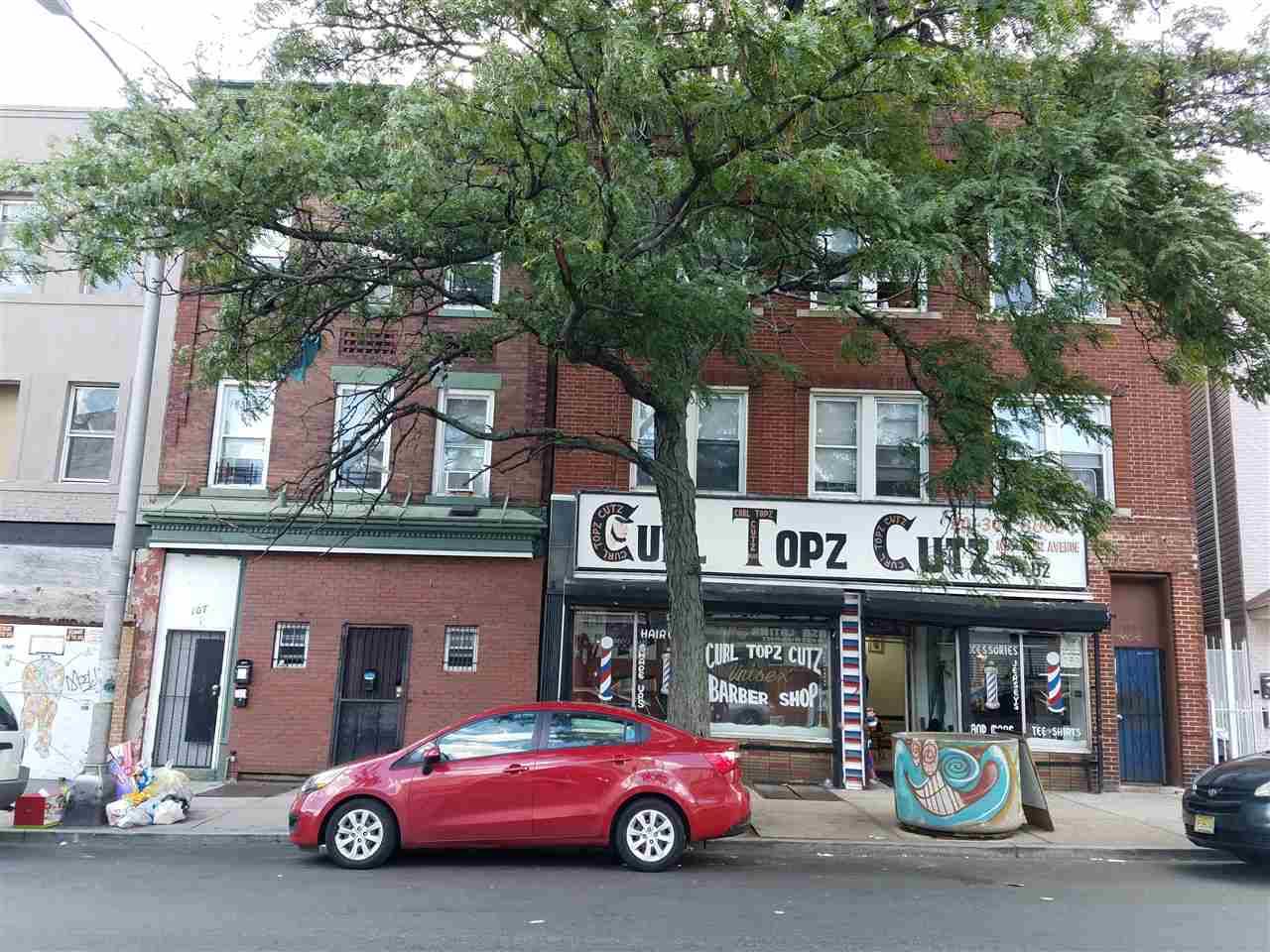 Mixed use solid brick building with retail space on street level and 2 three bedroom apartments on two above floors