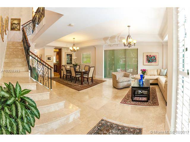 Located in tree-lined Alhambra Circle this corner 2-story town home is steps away from the bustling downtown Gables with its restaurants and shops