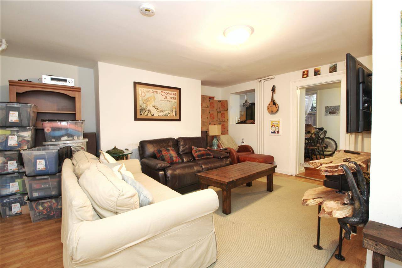 Huge 1 bedroom + den apartment with large kitchen and dining area that opens up to a private full backyard