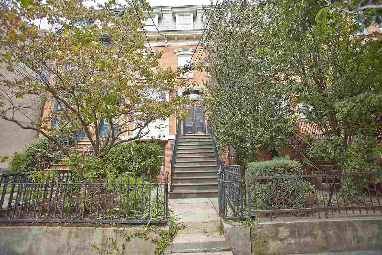 Beautiful brick Victorian townhouse with Mansard roof on one of the most picturesque streets in Downtown Jersey City