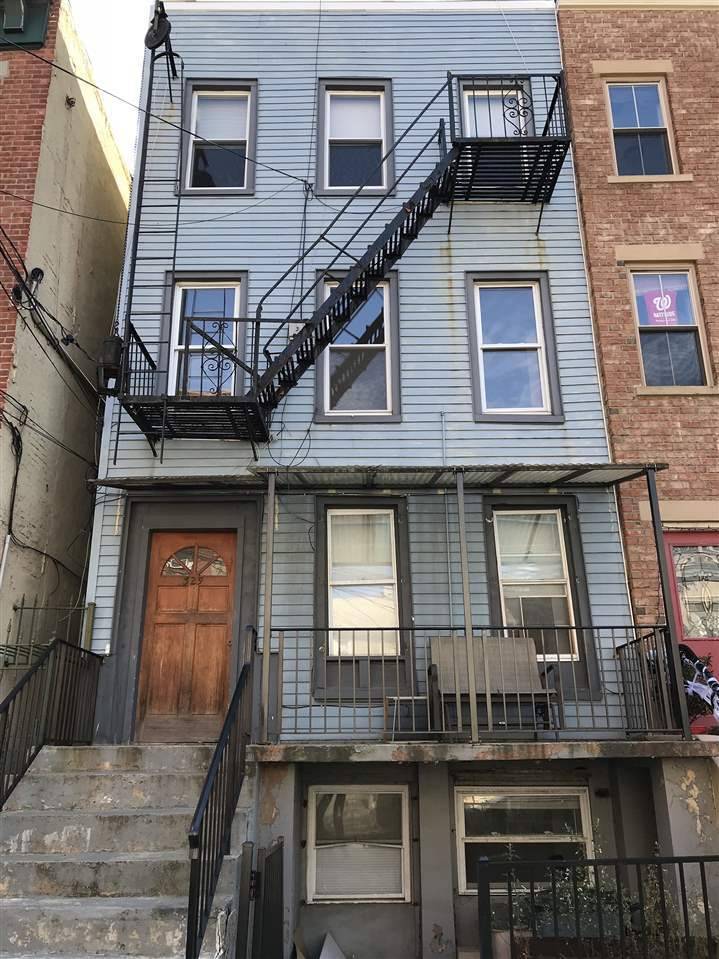 This three-family row house is in one of the most desirable new areas in Downtown Jersey City