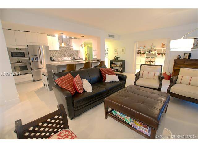 Completely updated corner unit by an interior designer in Botanica Key Colony Complex with private access to the Beach