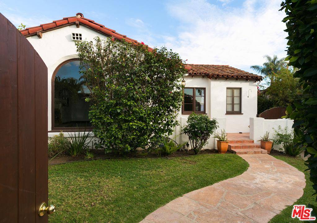 Classic 1930'S Spanish set behind tall privacy hedges on a charming tree-lined street in desirable Wilshire Vista