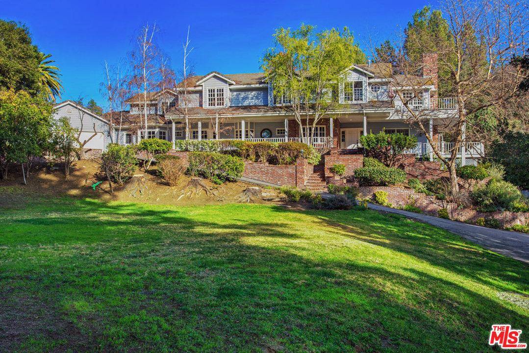 Up a long private driveway and perched on the top of the hill sits this amazing Hampton style estate