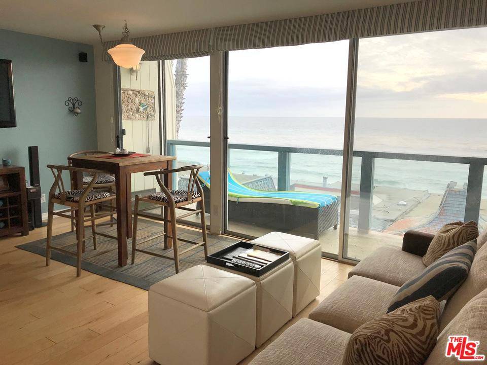 Enjoy panoramic ocean views from this 2-story condo just step away from a sandy beach