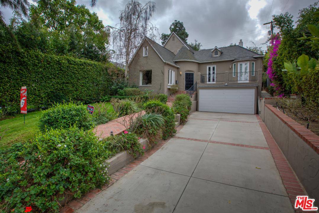 Perched up in the sought after Comstock Hills of Westwood is this meticulously designed and remodeled 1925 English Tudor two story home