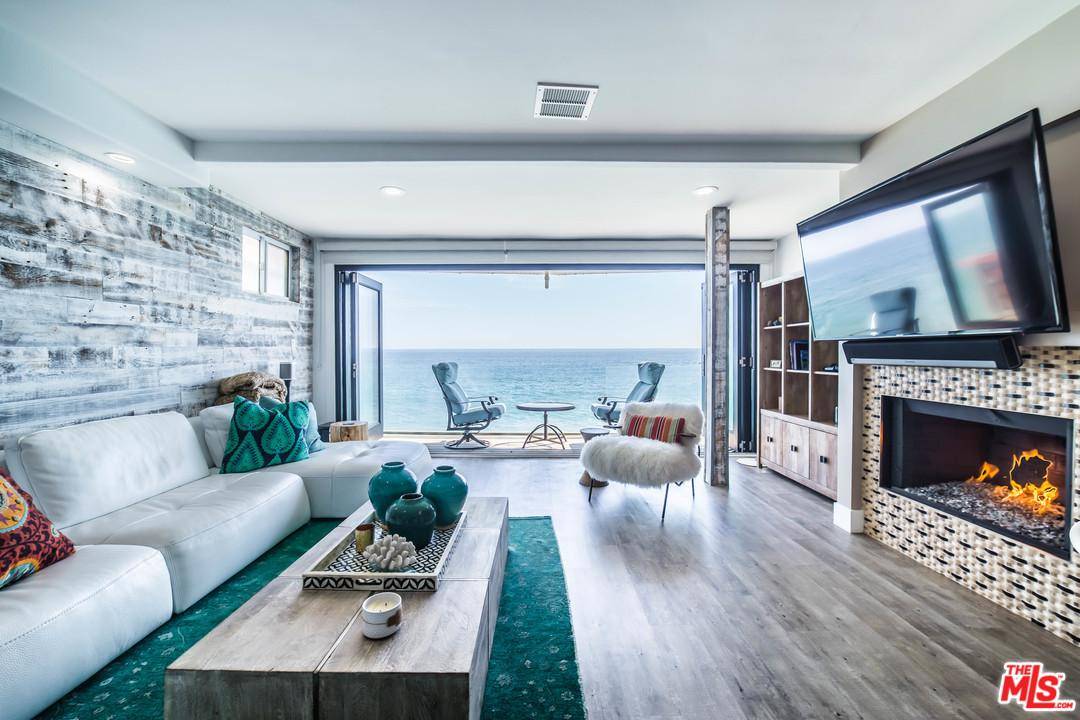 Tucked Away on famous Pacific Coast Highway in Malibu is the ultimate contemporary beachfront home