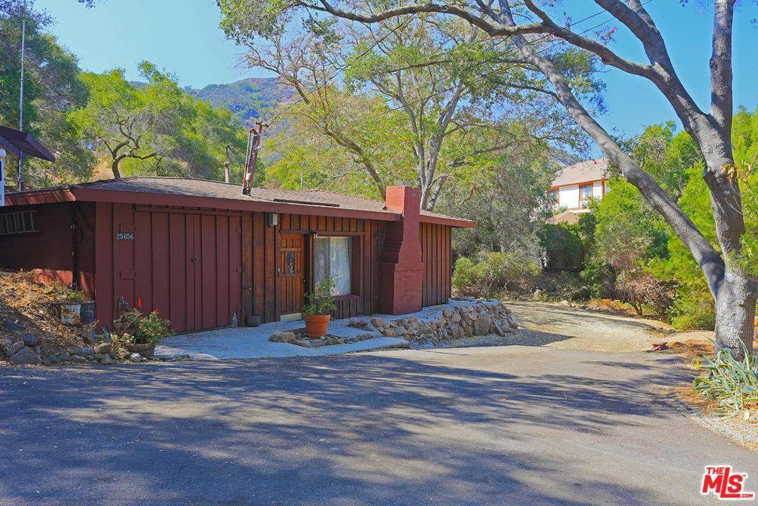 Pretty and private creekside location with loads of potential