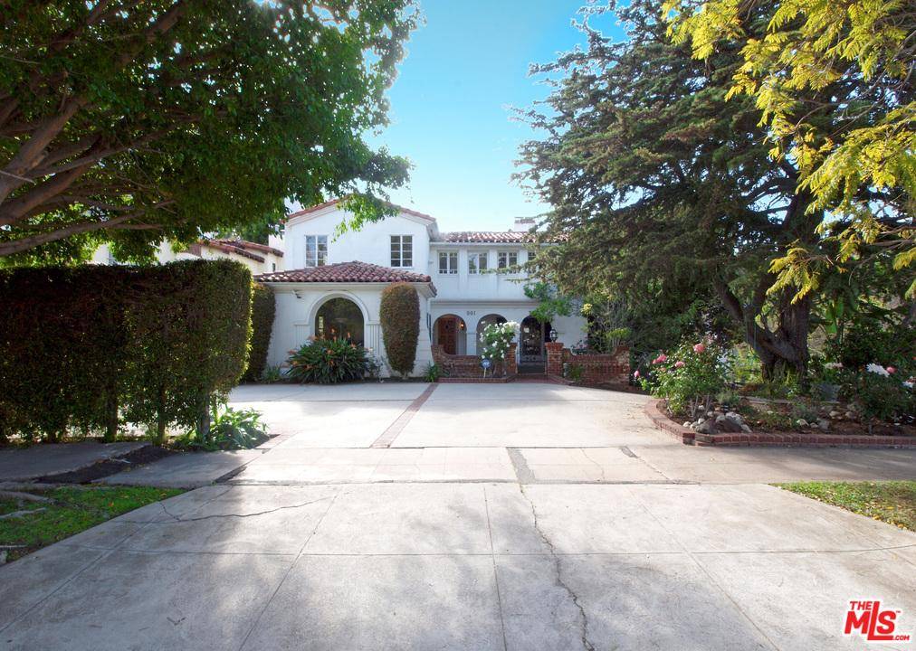 This spacious Spanish style home is set on a corner lot in prime Little Holmby