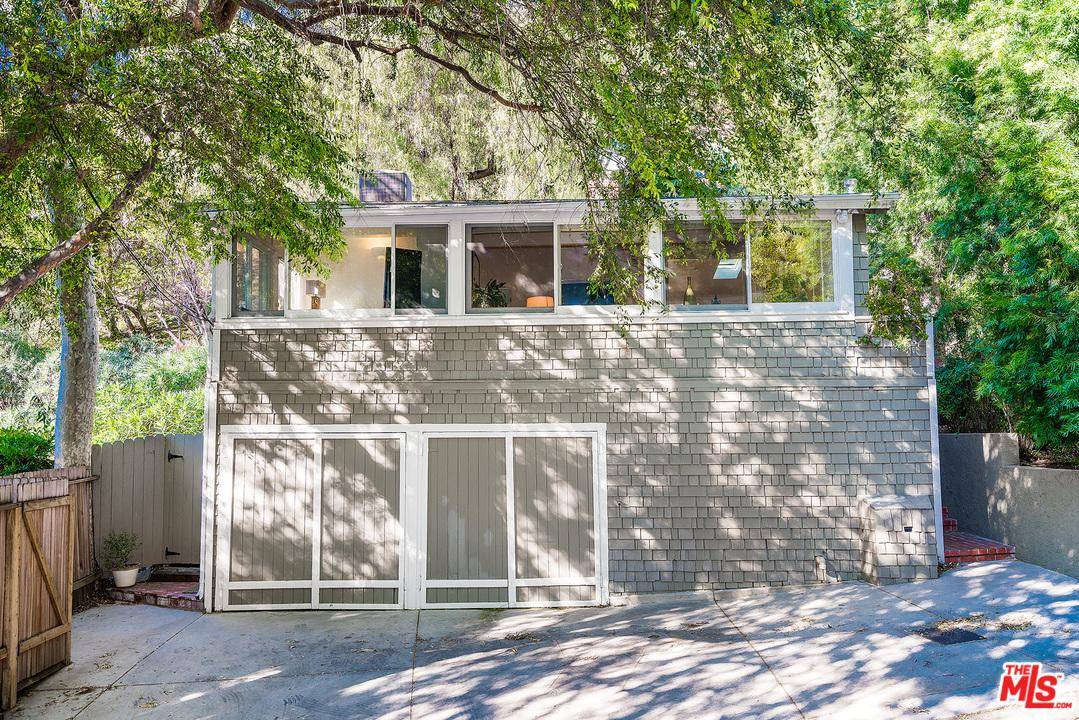 Tucked away off Benedict Canyon find this remodeled cottage on a rare double lot in a serene and verdant setting
