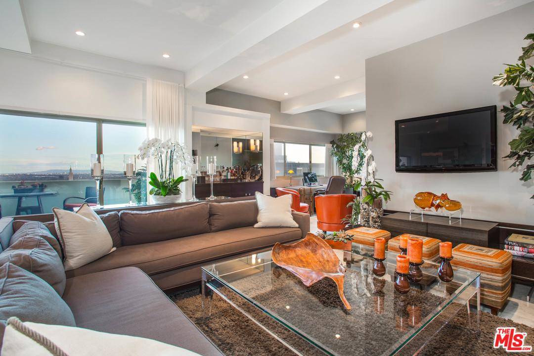 A stunning warm contemporary and remodeled 2+ Den condo with sweeping city lights views to the ocean at the prestigious Crown Towers