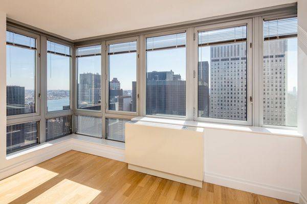 No Broker Fee + 1 Month Free Rent!!!   Limited Time Only!!!   Sprawling Midtown East 2 Bedroom Apartment with 2 Baths featuring a Fitness Center and Rooftop Deck