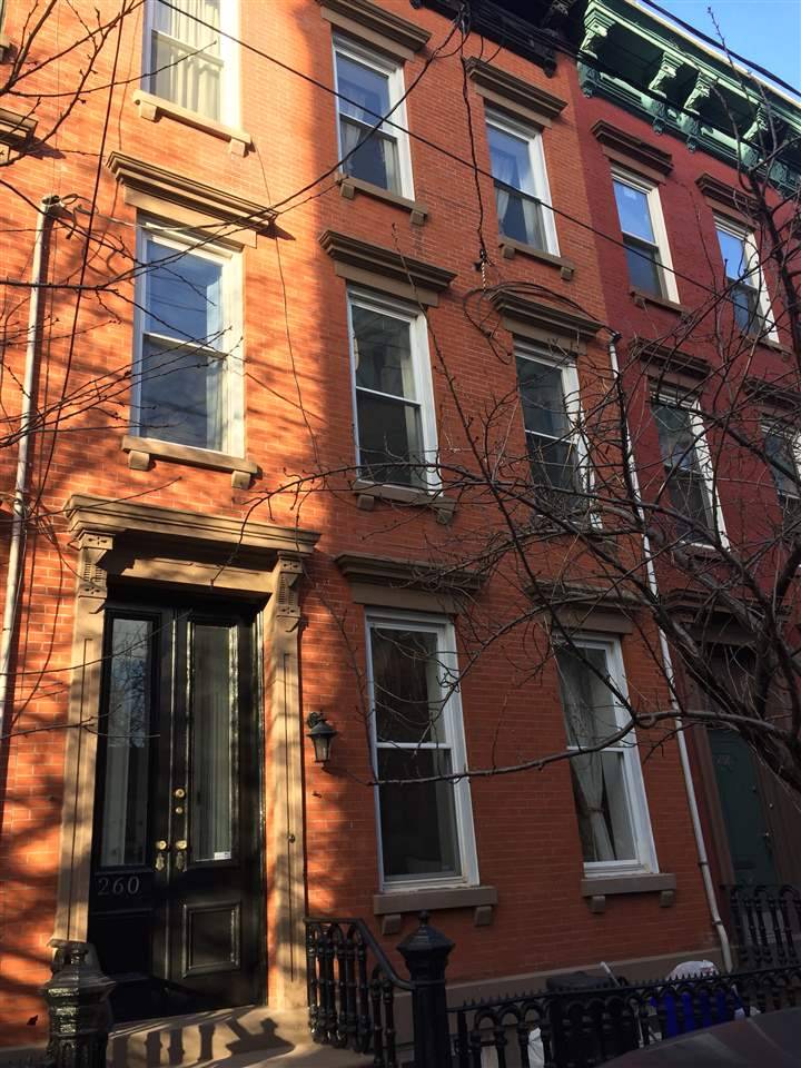 This three windows wide four-story single-family townhome on a 21'x61' lot is located on one of Hoboken's beautiful uptown blocks