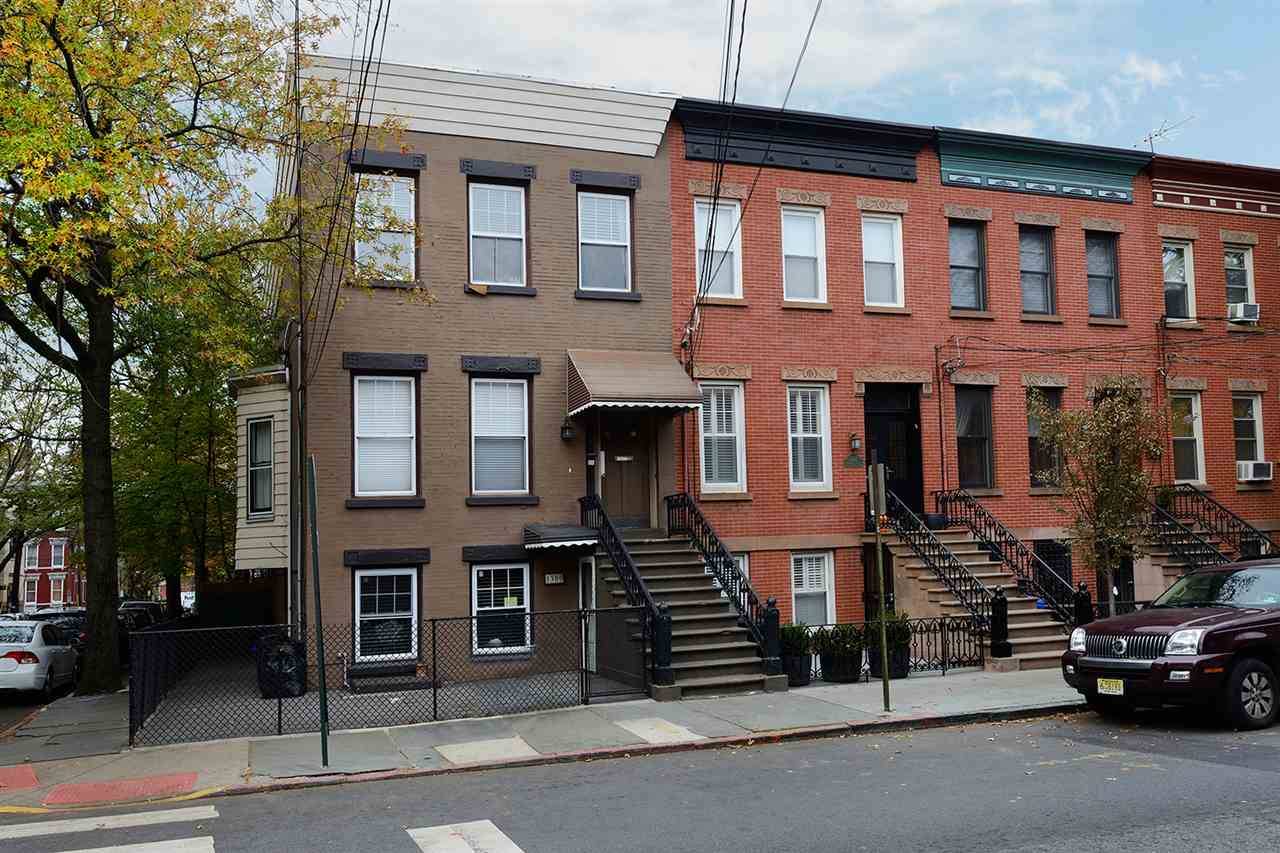 Move right into this beautiful corner brick row house with streaming sunlight from three sides