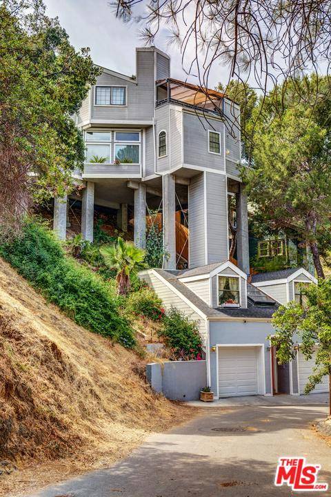 Rise above the trees in this truly unique architectural property located in the desirable Hollywood Dell