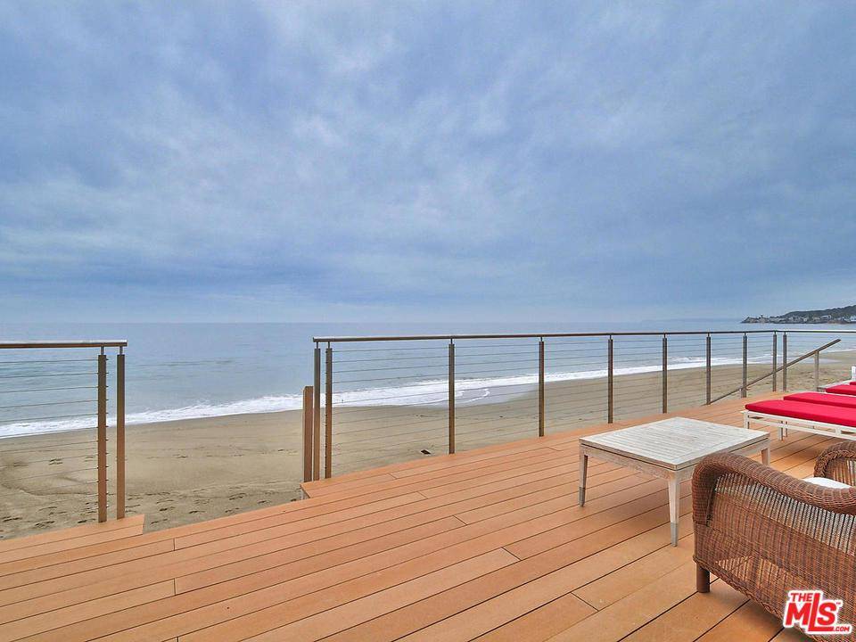 Modern style sophisticated five bedroom beach front home located in the famous guard gated Malibu Colony