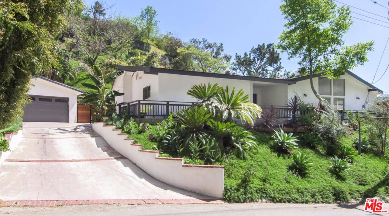 This private and serene single-level traditional home in prime Beverly Hills Post Office showcases a gracious