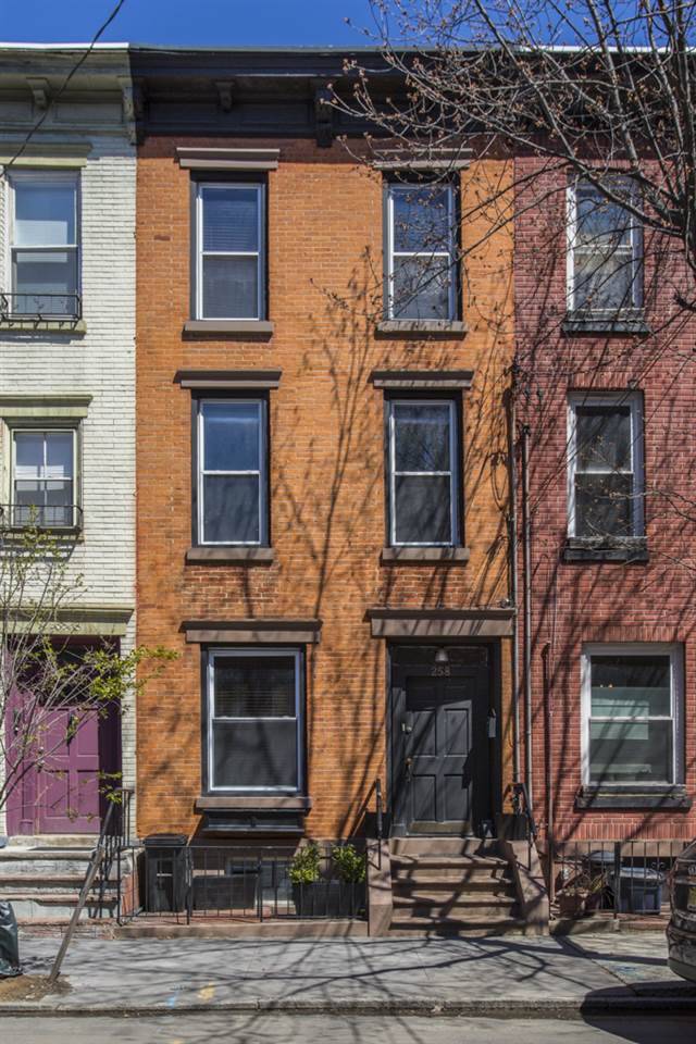 Beautiful original brick row home on a gorgeous tree lined street in downtown Jersey City