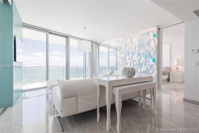 Enjoy breathtaking direct ocean views from this redesigned & modern 2 BR with den smart residence at the Jade Beach