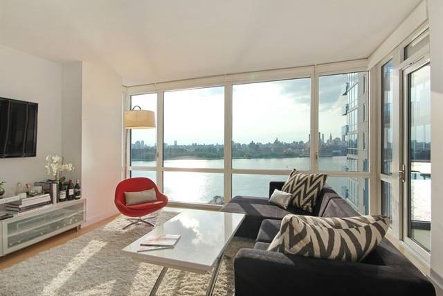 The EDGE Absolutely Stunning 1 Bedroom with Gorgeous Direct City, Empire State Building and River Views with Private Balcony in a Full Service White Glove Luxury Building The living room ...