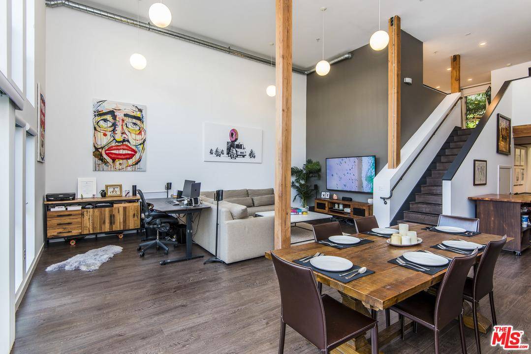 Step into this beautiful two-story modern loft with open kitchen and south facing sun-drenched living room with 18' ceilings and