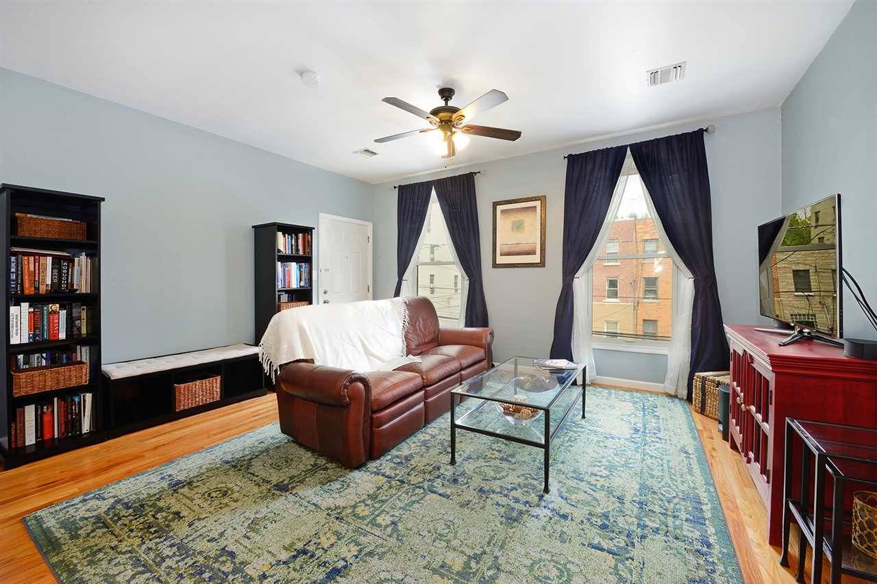 Expansive and sunny 3 bedroom/2 bathroom condo with a sweeping layout in a quaint downtown Jersey City boutique building