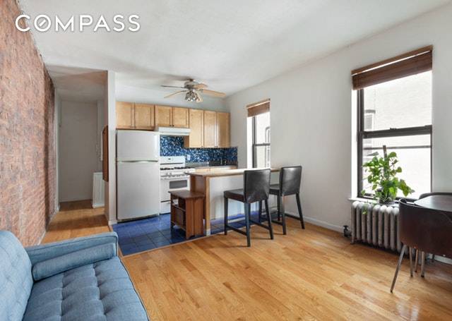 Apartment 3B has an open kitchen and extra large bedroom with three windows.