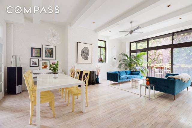 West Village dream a soaring 3 bedroom loft with a balcony and a fireplace in one of New York's most charming buildings.